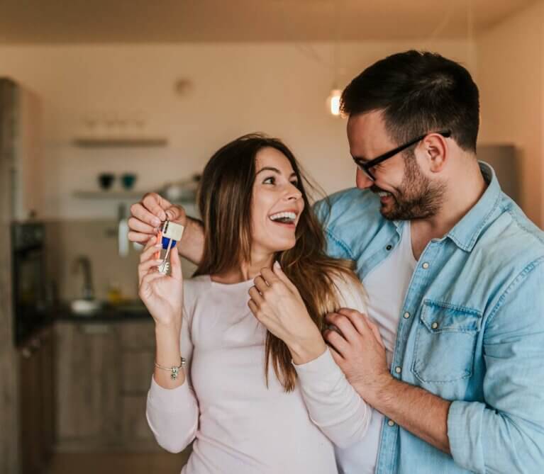 excited couple moving into a new house